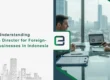 Business executive reviewing nominee director agreements for foreign-owned business in Indonesia with laptop and legal documents on desk